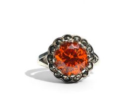 A silver, Marcasite and orange stone set ladies ring. Stamped S925.