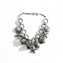 A Sterling silver 'Sea life' charm bracelet. Stamped 925. Fitted with shell, stars, crabs and Turtle