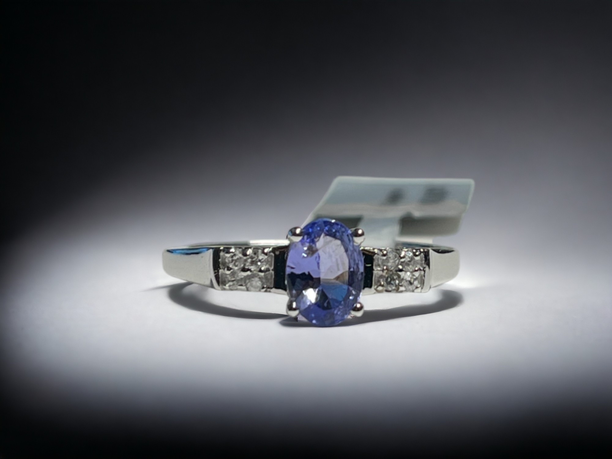 A 9CT white gold & Tanzanite ladies ring.  Set with an oval cut solitaire 0.75ct Tanzanite accented 