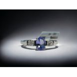 A 9CT white gold & Tanzanite ladies ring.  Set with an oval cut solitaire 0.75ct Tanzanite accented 