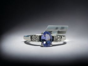 A 9CT white gold & Tanzanite ladies ring.  Set with an oval cut solitaire 0.75ct Tanzanite accented
