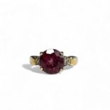 A ladies 9ct Gold ring. With large central coloured stone accented with diamonds. 