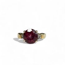 A ladies 9ct Gold ring. With large central coloured stone accented with diamonds.