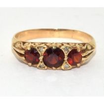 9ct gold ladies Vintage garnet dress ring with scroll decoration size O