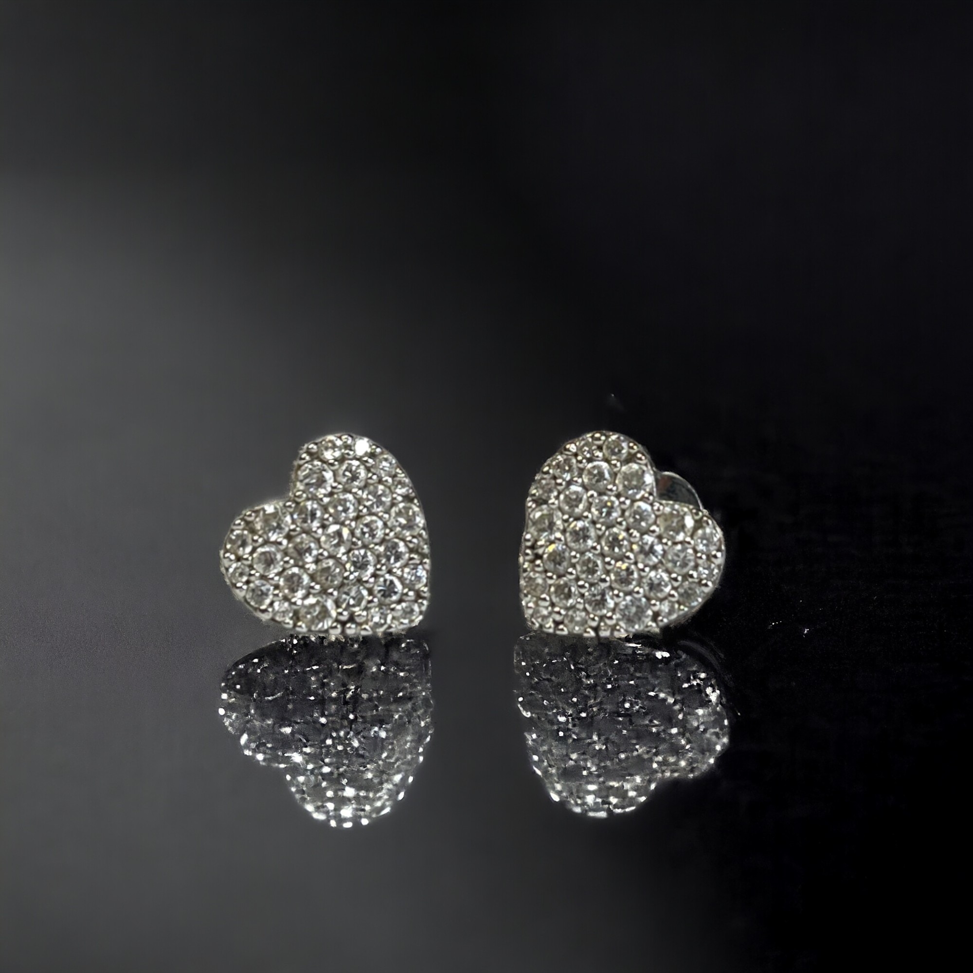 A pair of 9ct white gold stone set heart earrings. Stamped 375. Approx. 1.6g 