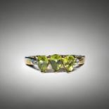 A 9ct Gold and peridot ladies ring. Set with three pear shaped Peridot's and small accent diamonds t