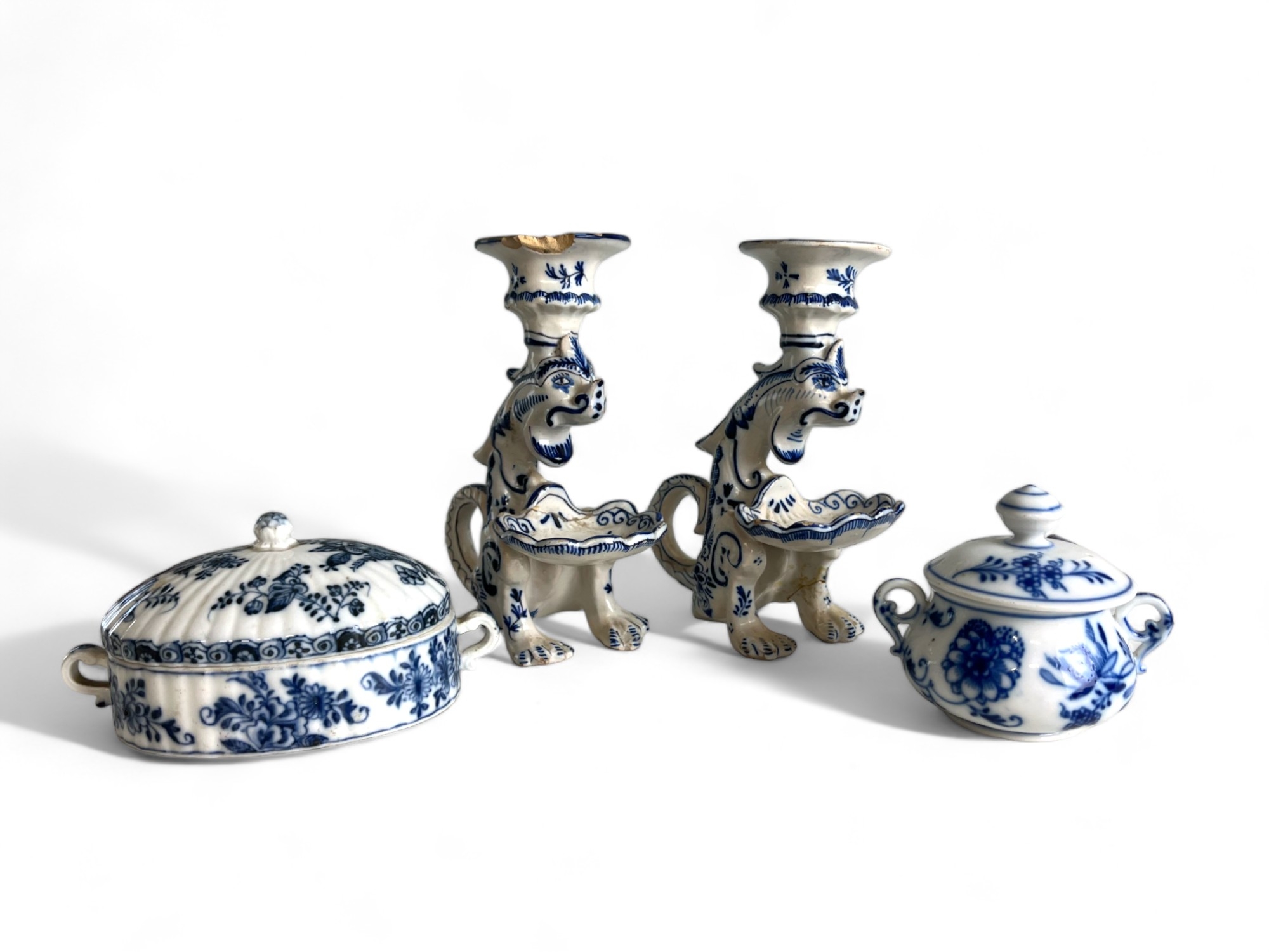 A pair of Continental Delft 'Gothic' Dragon candlesticks, together with a pair of German blue & whit