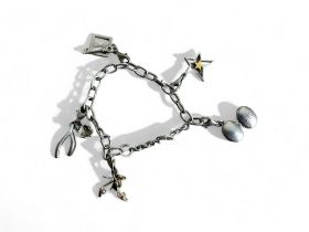 A silver charm bracelet. Marked 925. Fitted with five miscellaneous charms. Weight - 22.3g