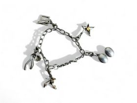 A silver charm bracelet. Marked 925. Fitted with five miscellaneous charms.  Weight - 22.3g 