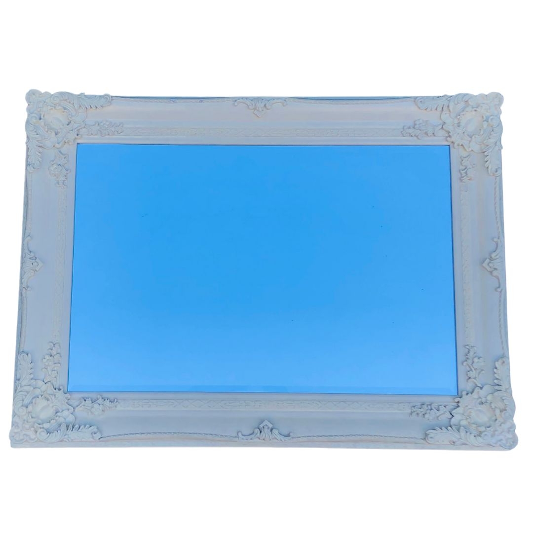 Cream Coloured ornate Moulded Frame Containing Bevelled Mirror. Approx 112cm x 82cm 