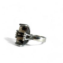 A large sterling silver ladies ring. Set with a very large coloured stone, probably smoky quartz.  S