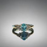 A ladies 9ct Gold ring. Set with central blue stone, possibly Topaz? bordered with six diamonds.  Si