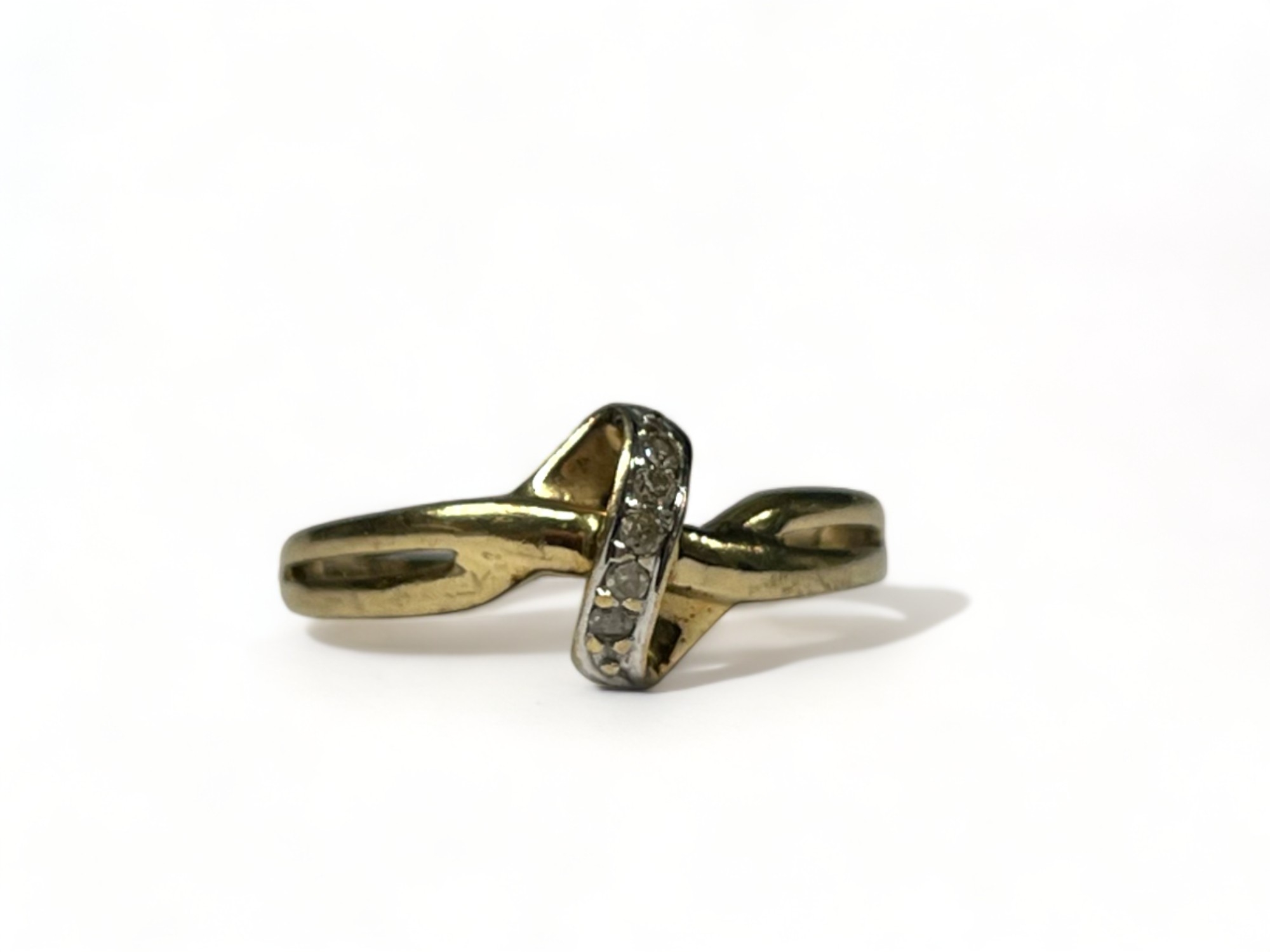 A 9ct gold & diamond cross over ring. Size - k 1/2. Approx. 1.3g 