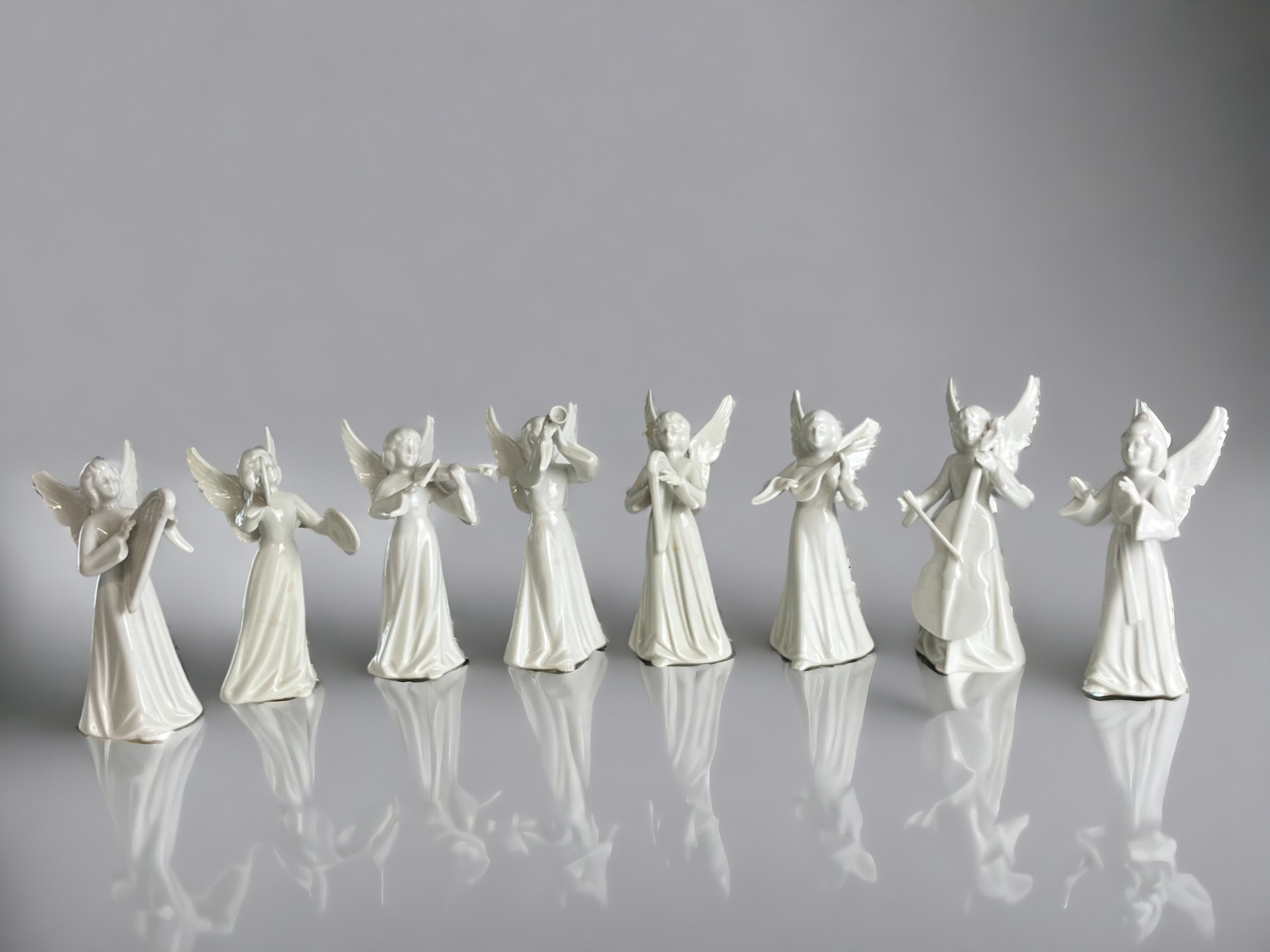 A collection of eight Dresden porcelain angels. 