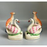 A pair of 19th century Staffordshire 'Whippet' seated dogs, together with a pair of 'Swan' inkwells.