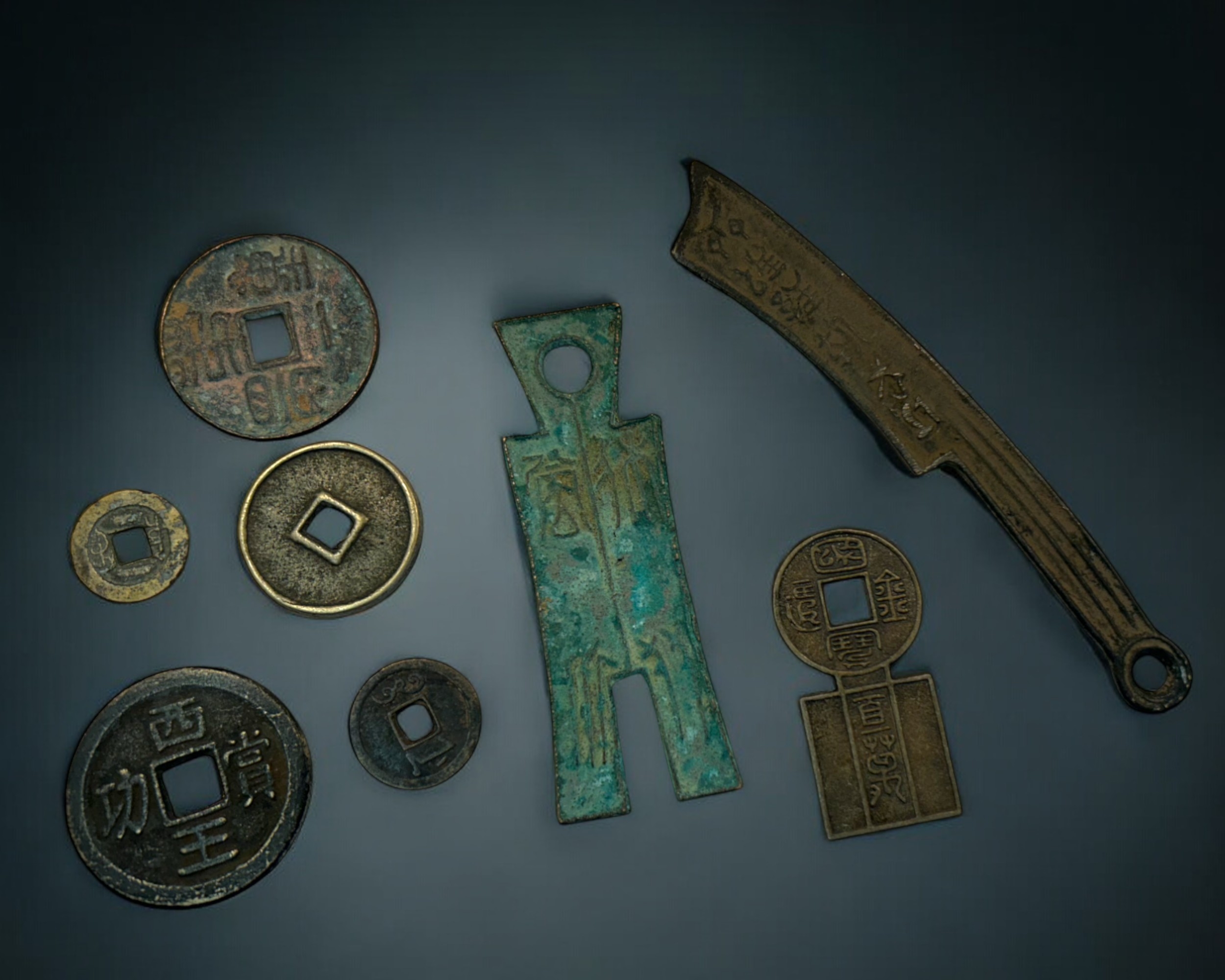 A collection of Chinese trade coins. Includes Qi knife, Ch Spade and various coins.