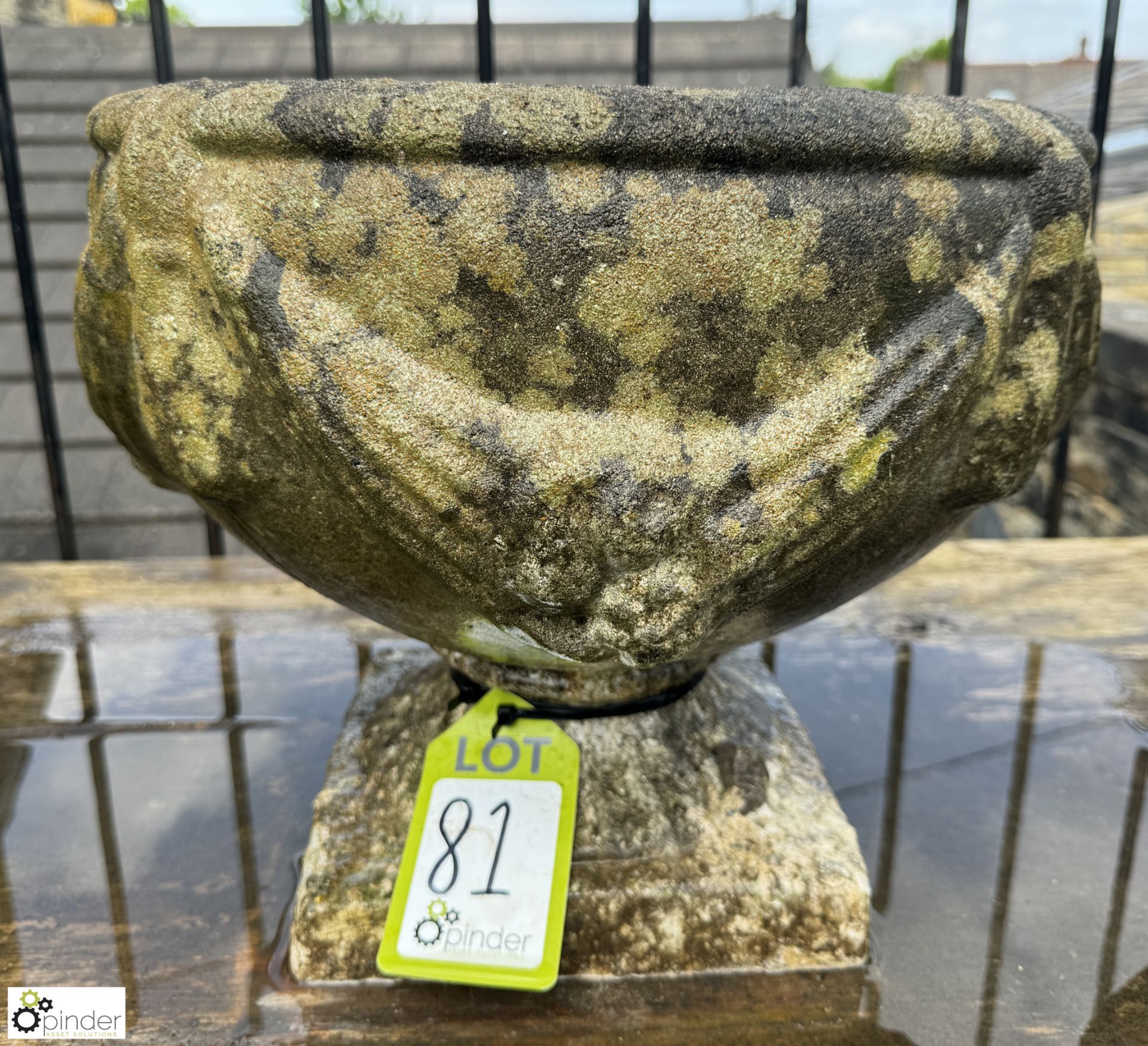 A reconstituted stone Urn, with swag of fruit decoration, approx. 14in x 16in diameter