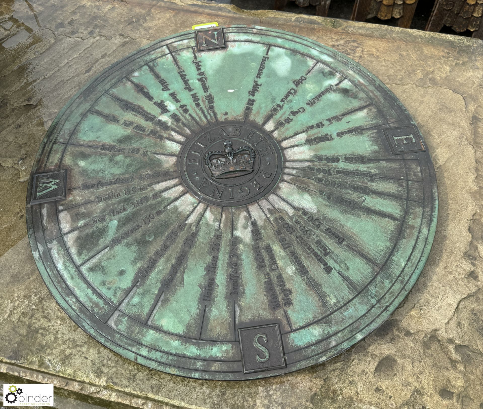 A large bronze Plaque depicting the 4 points of a compass, North, East, South, West, with a crown