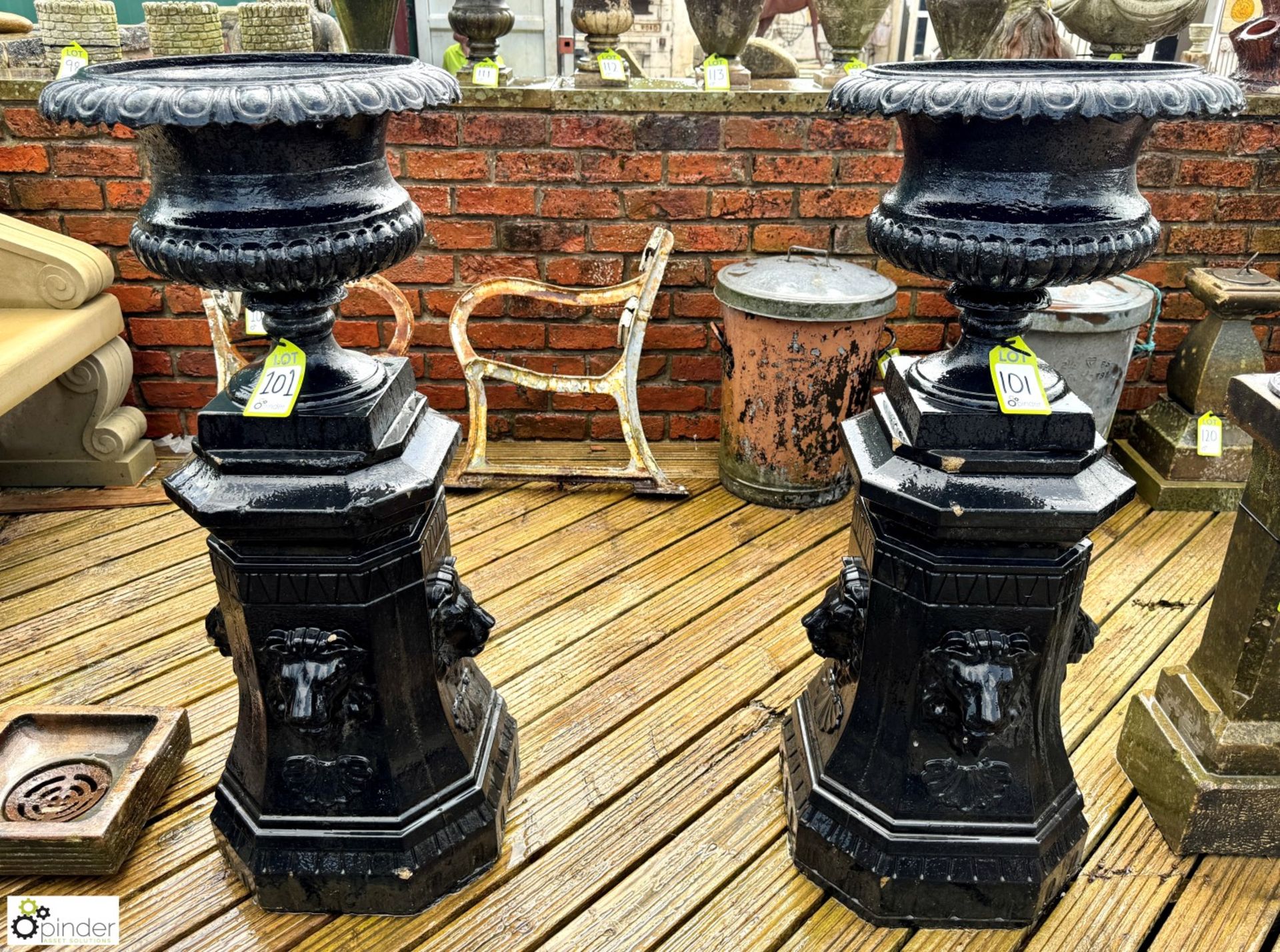 A pair cast iron Garden Urns, with egg and dart gadrooning decoration, on reconstituted stone