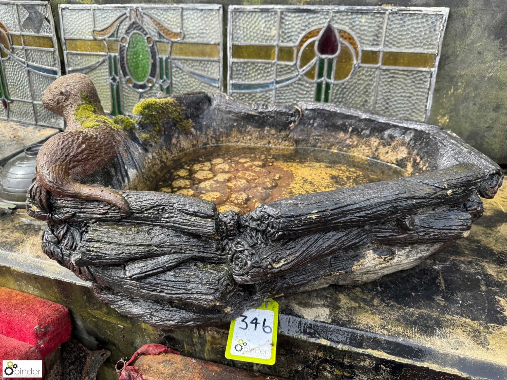A reconstituted stone Water Feature depicting an otter and faux bois decoration, approx. 7in x 28in