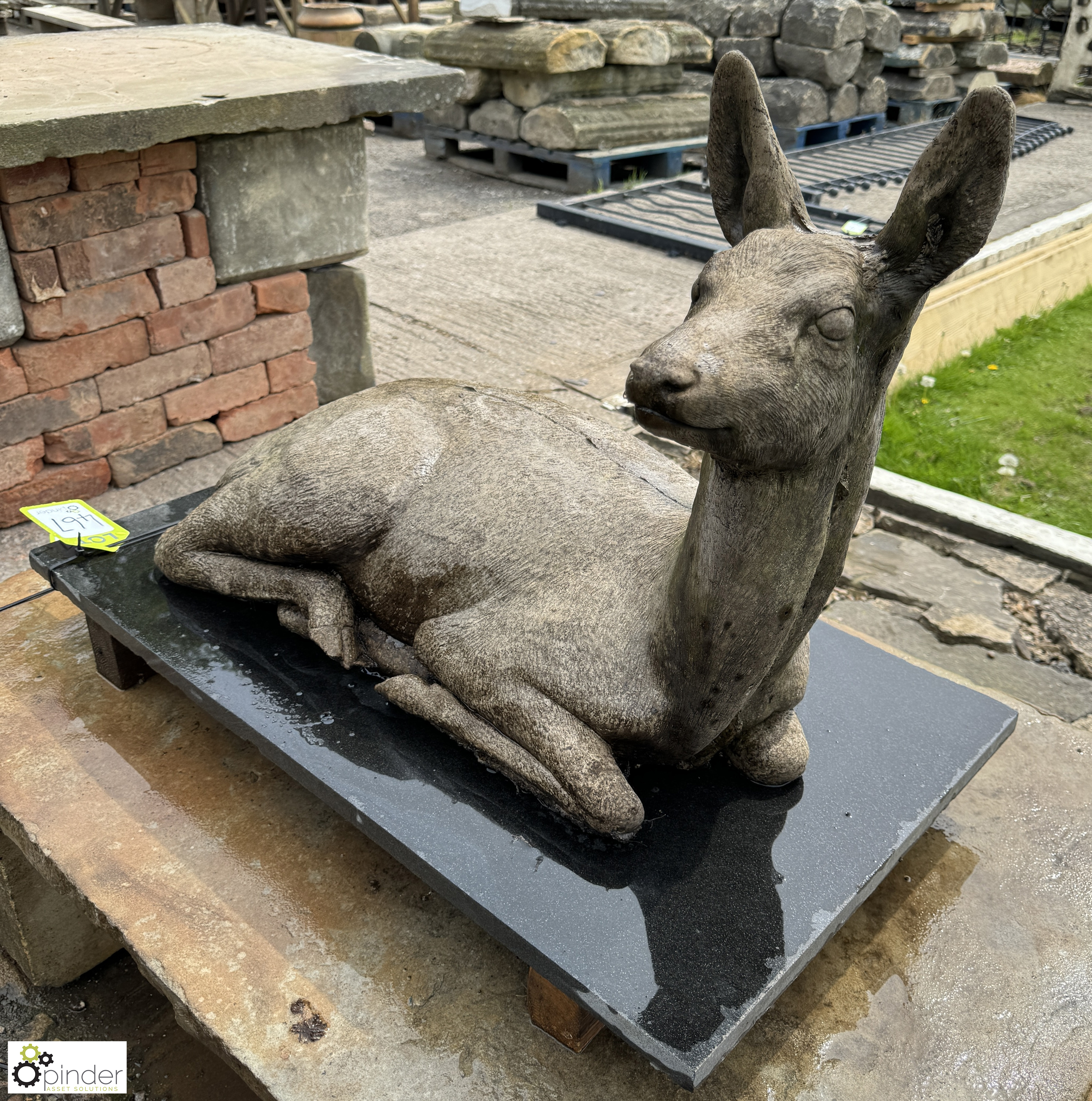 A reconstituted stone seated Deer, on black marble plinth, approx. 20in x 17in x 31in - Image 7 of 8