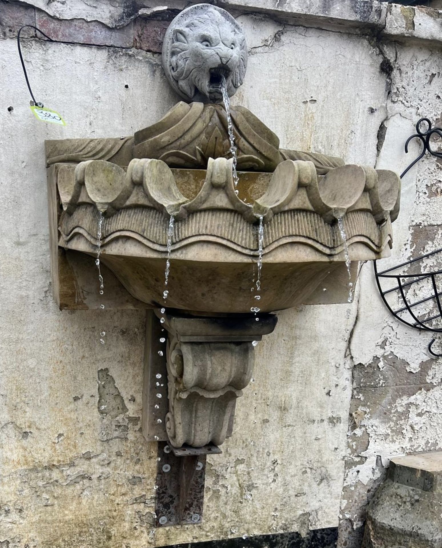 A Wall Fountain comprising reconstituted stone lions head waterspout, mounted above a sandstone clam - Image 5 of 13