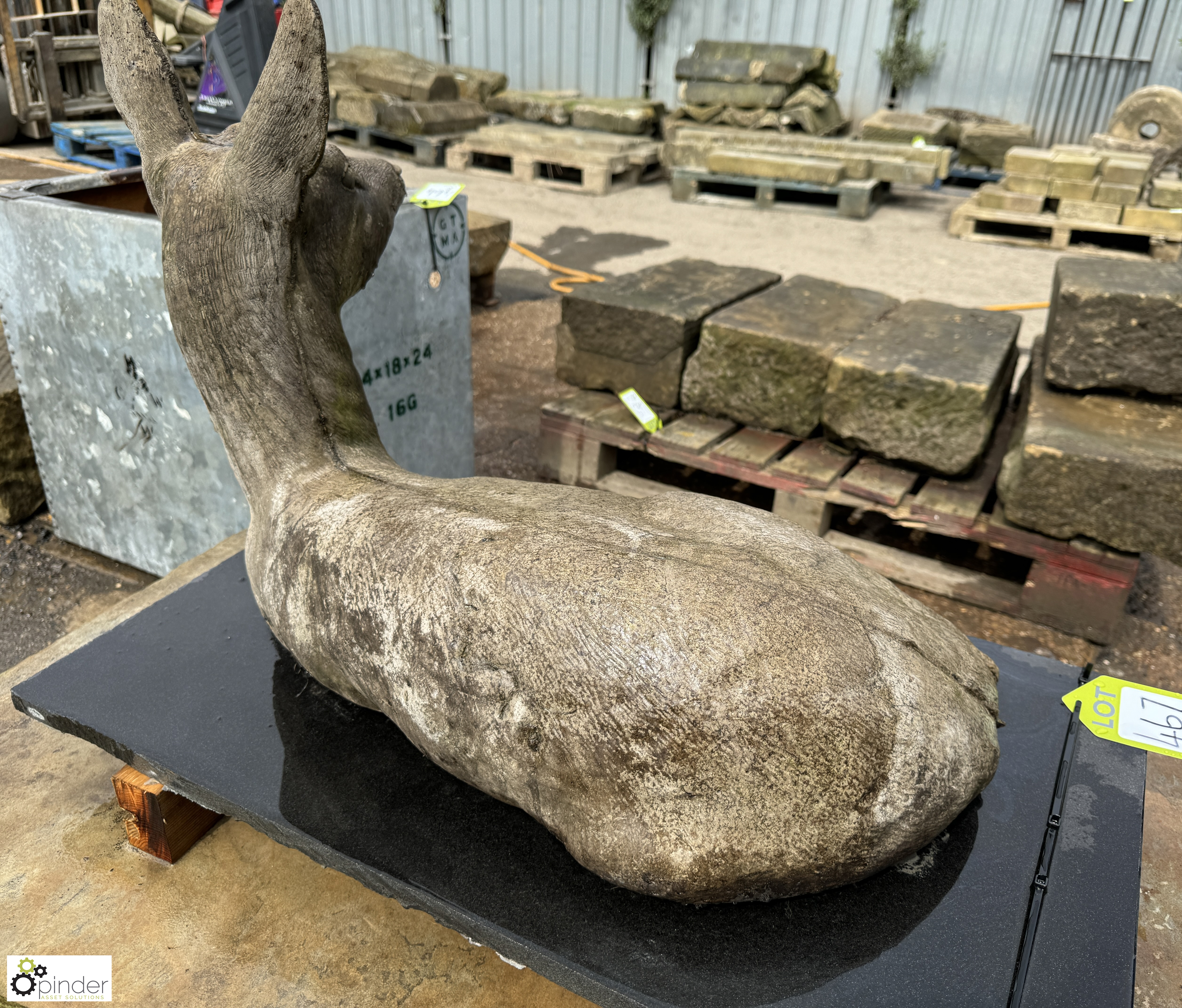 A reconstituted stone seated Deer, on black marble plinth, approx. 20in x 17in x 31in - Image 5 of 8