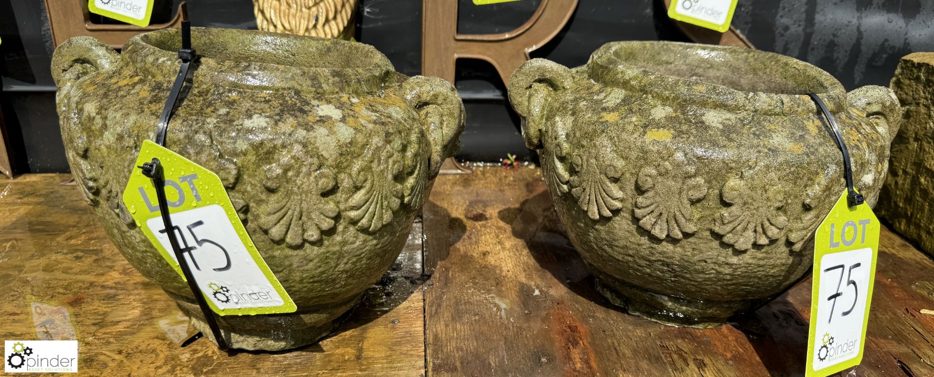 A pair round reconstituted stone Planters, with classical honeysuckle and ring handle decoration,