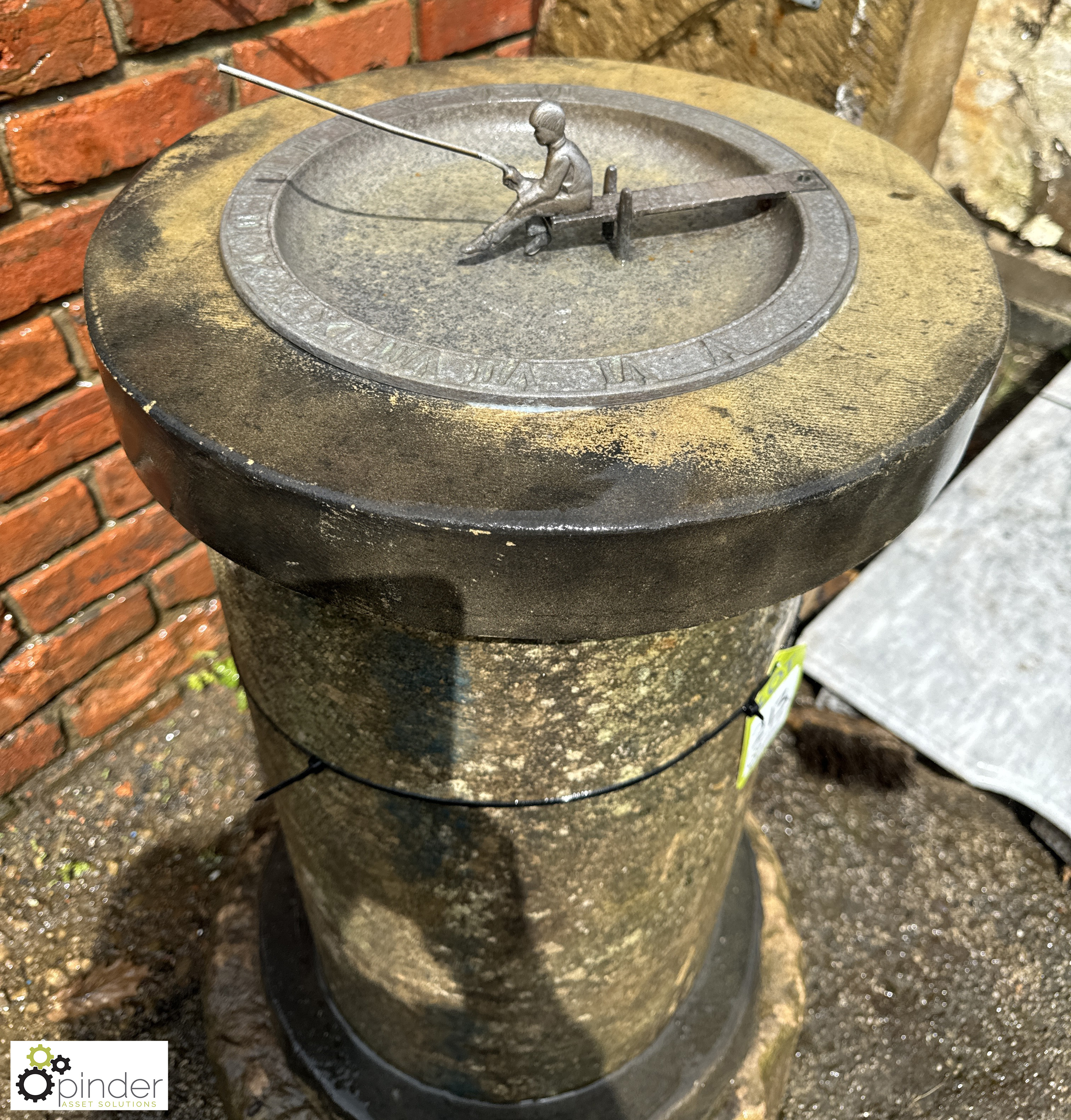 An original Birdbath and Sundial, decorative gnomon of a young boy fishing on a pier, with Roman