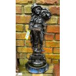 A cast iron Stick Stand, marked the reaper, depicting a man carrying a scythe and sheaf of wheat,