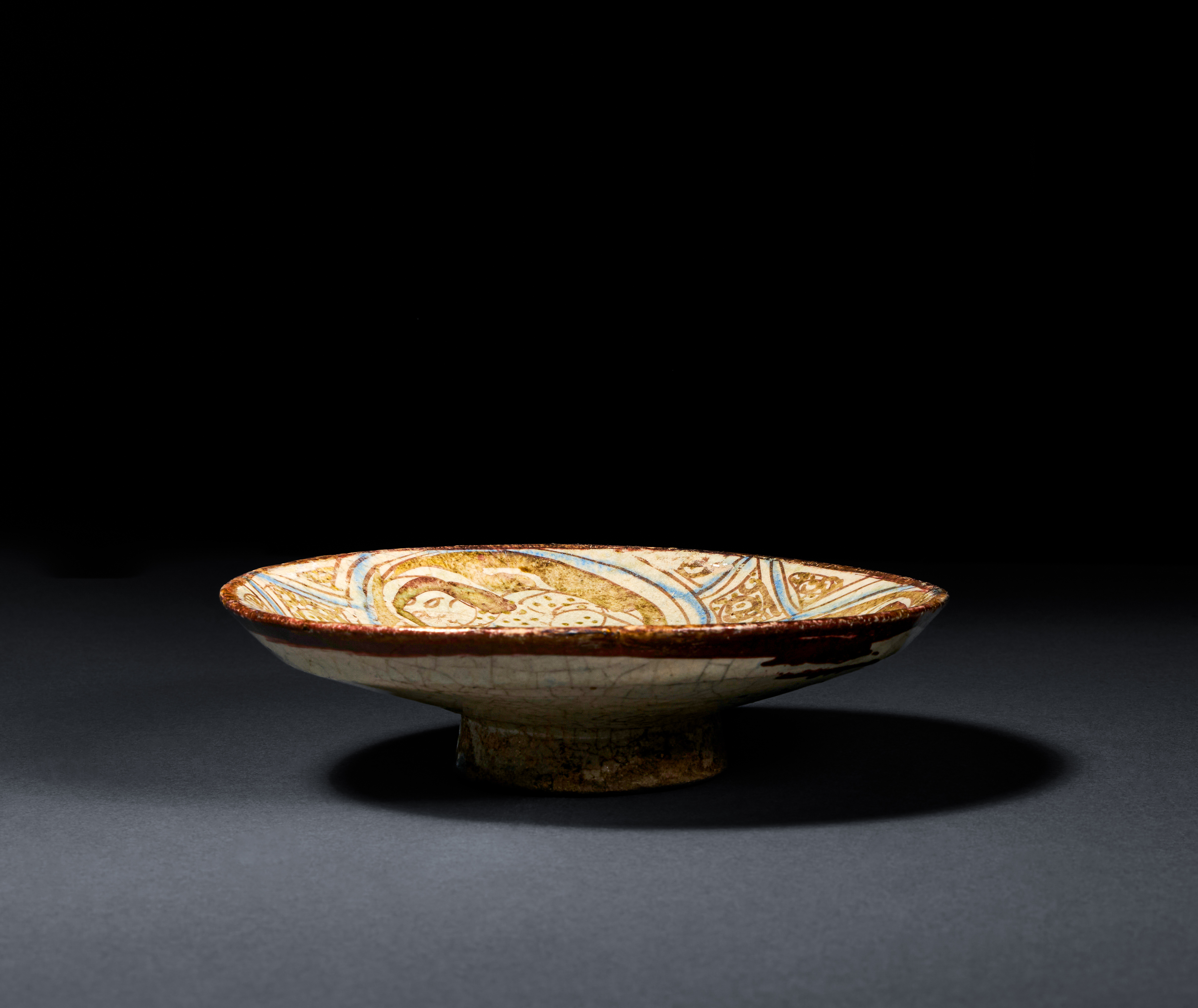 A RARE FIGURAL KASHAN LUSTRE POTTERY DISH CENTRAL IRAN, EARLY 13TH CENTURY - Image 2 of 3