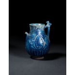 A RARE KUFIC INSCRIBED SELJUK MONOCHROME MOULDED POTTERY JUG, 12TH CENTURY, PERSIA