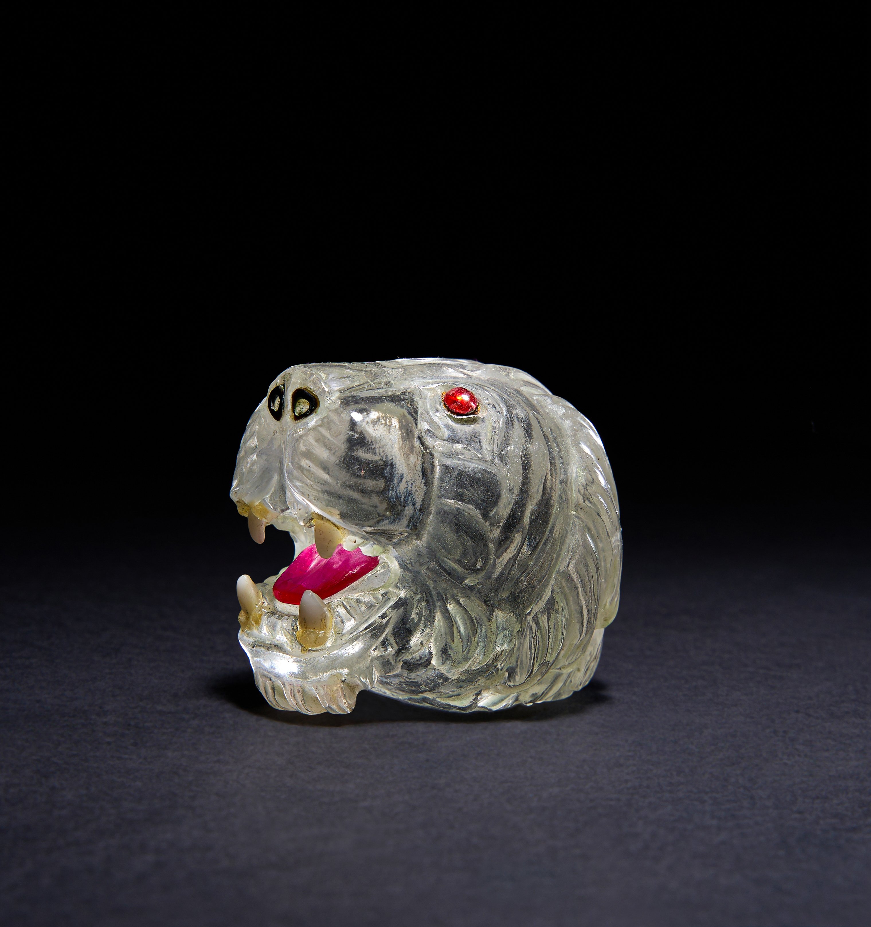 A LARGE MUGHAL GEM SET ROCK CRYSTAL CARVING OF A TIGHER HEAD WITH RUBY EYES & TONGUE, 18TH/19TH CENT