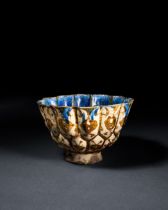 A RARE BLUE SLIP PAINTED KASHAN LUSTRE POTTERY BOWL, CENTRAL IRAN, EARLY 13TH CENTURY