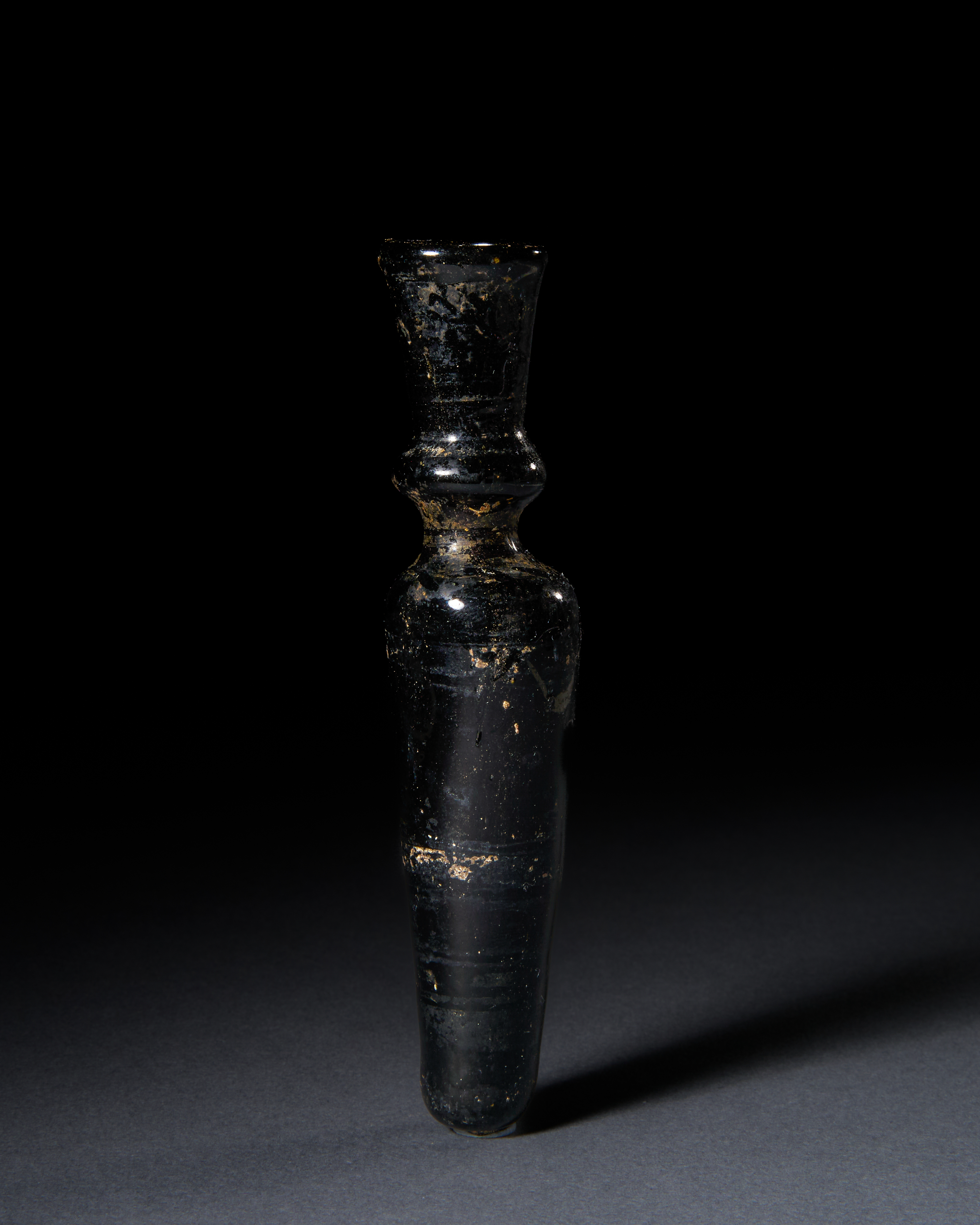 A BLACK GLASS FATIMID COSMETIC VASE, 9TH CENTURY, EGYPT
