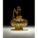 A HIGHLY RARE FATIMID FLUTED YELLOW GLASS EWER, CIRCA 10TH CENTURY, EGYPT