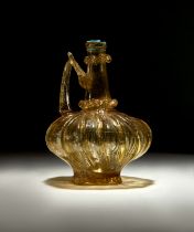 A HIGHLY RARE FATIMID FLUTED YELLOW GLASS EWER, CIRCA 10TH CENTURY, EGYPT