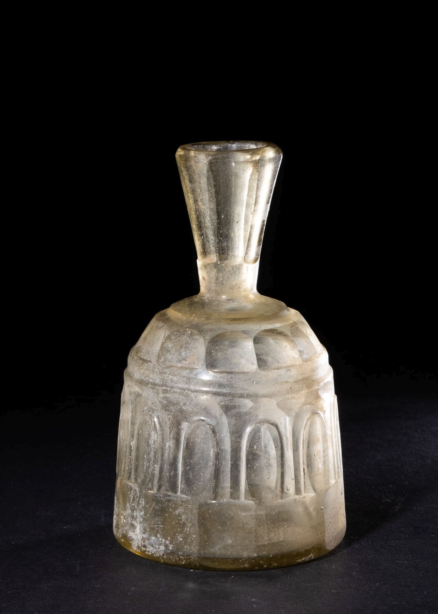 AN INTACT WHEEL-CUT CLEAR GLASS BOTTLE, ABBASID, 9TH CENTURY