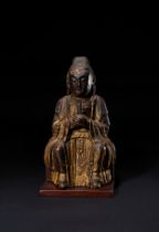 A CHINESE GILT-LACQUERED WOODEN FIGURE OF A SEATED BUDDHA, 17TH CENTURY