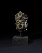 A BRONZE HEAD OF A BUDDHA