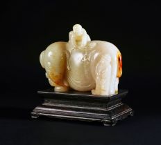 A CHINESE WHITE JADE 'ELEPHANT AND BOY' GROUP ON A ZITAN STAND, QIANLONG PERIOD (1736-1795)