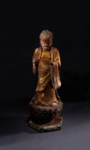 A LARGE GILT LACQUERED WOOD FIGURE OF A STANDING BUDDHA OF MEDICINE, MING DYNASTY (1368-1644)