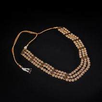 AN INDIAN PEARL SET GOLD TRIPLE STRAND NECKLACE ON ENAMEL, 20TH CENTURY, INDIA