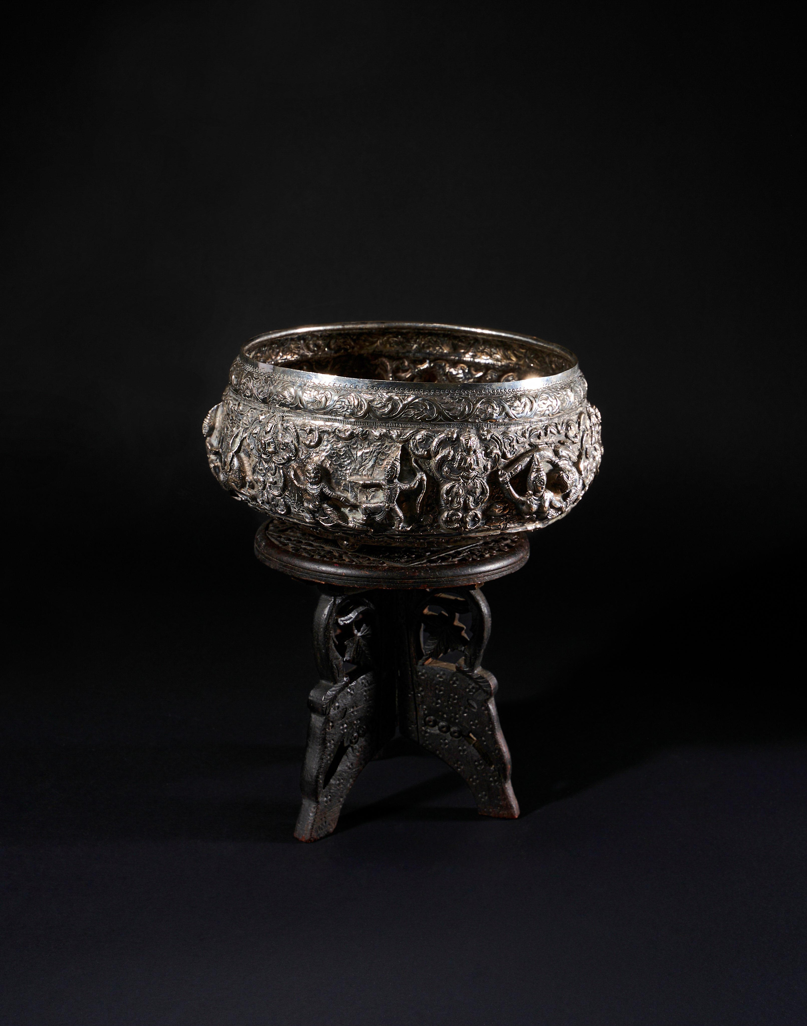 A SILVER BURMESE BOWL & WOODEN STAND, 19TH CENTURY