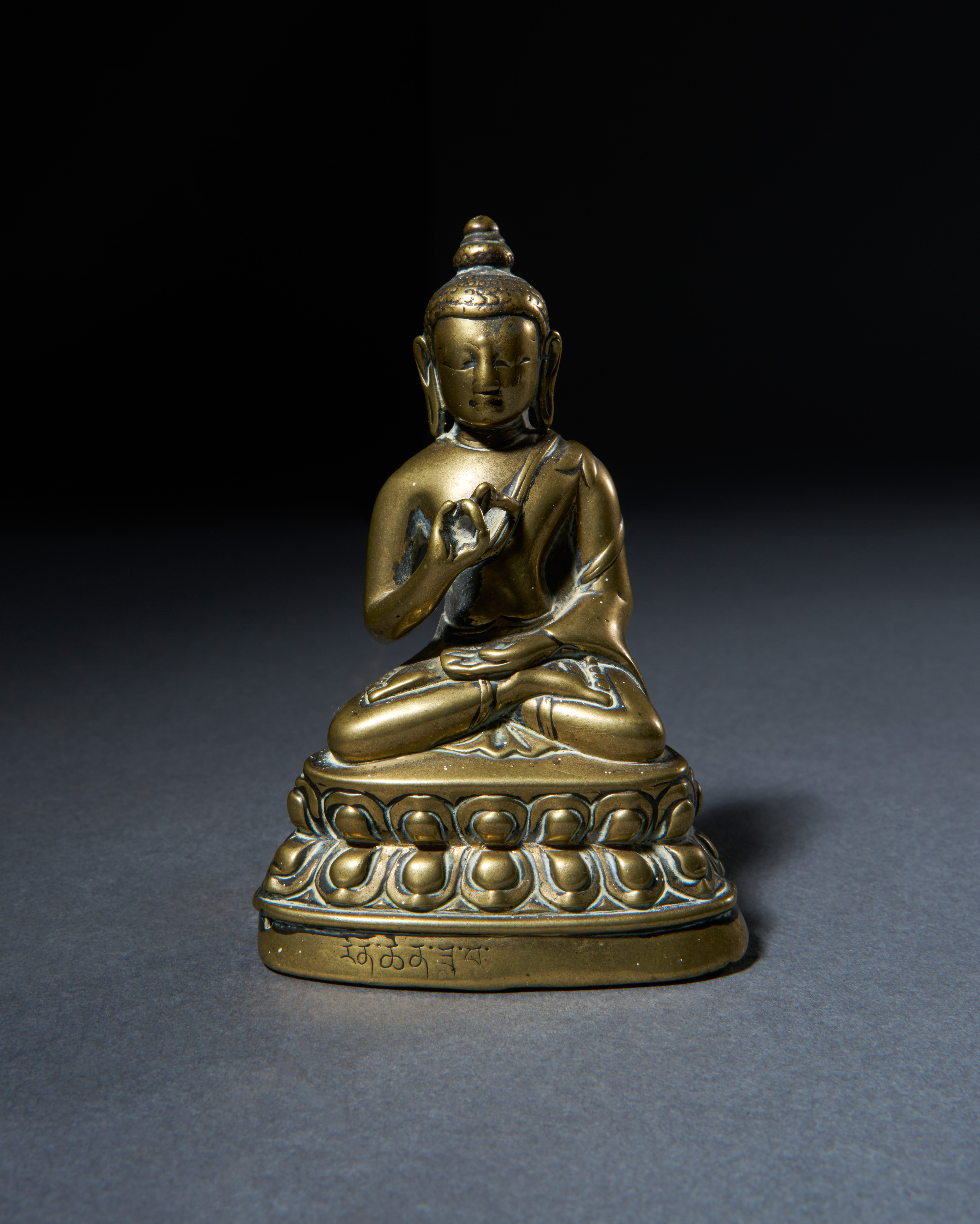 AN INSCRIBED GILT BRONZE BUDDHA, HIMALAYAN