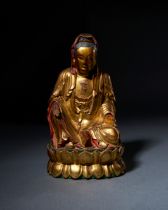 A GILT LACQUERED WOODEN FIGURE OF A SEATED GUANYIN