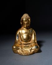 A GILT BRONZE FIGURE OF A SEATED BUDDHA