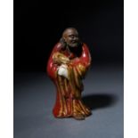 A CHINESE SHIWAN FIGURE OF A BUDDHA, QING DYNASTY (1644-1911)