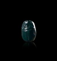 AN EGYPTIAN GREEN STONE HEART SCARAB