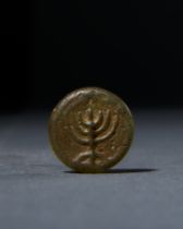 A ROMAN GLASS MENORAH AMULET, CIRCA 1ST CENTURY A.D.